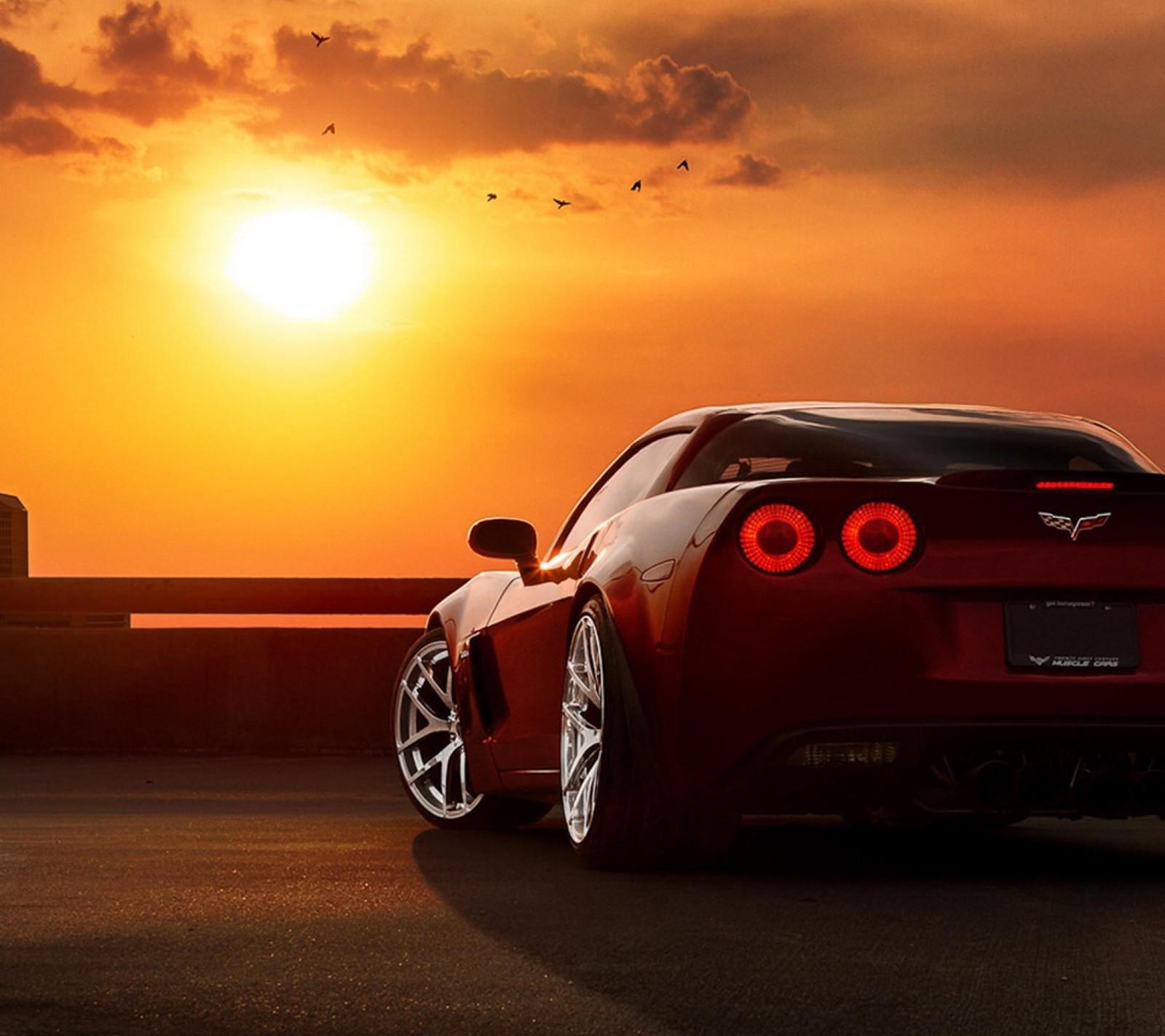 A close up of a red sports car parked on a road (car, corvette, red)