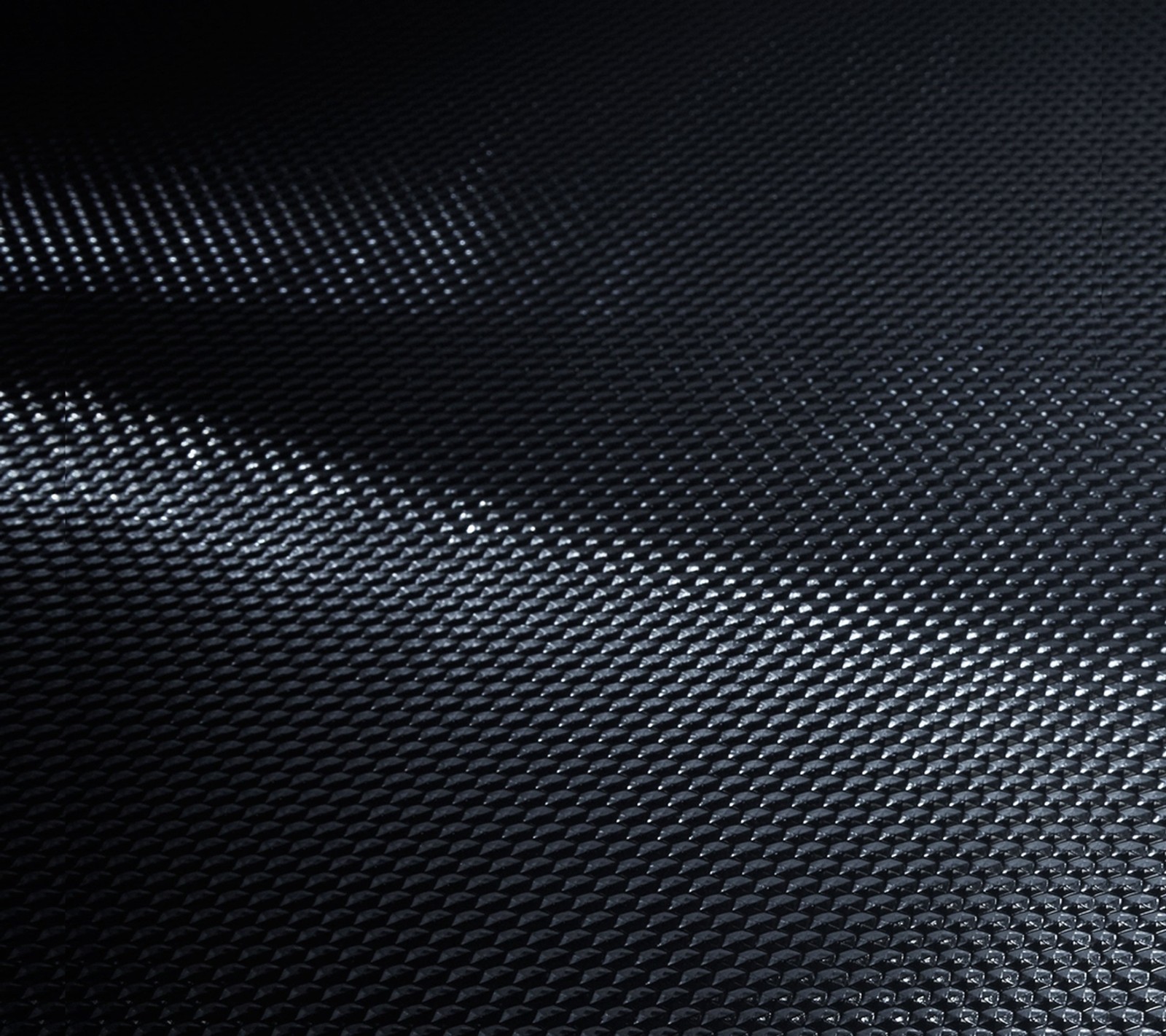 A close up of a black background with a pattern of small squares (carbon, fiber, galaxy, gs4, samsung)