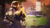 Master Chief in a vibrant battle royale landscape, ready for action in Fortnite.