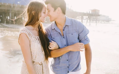 Intimate Beach Embrace: A Young Couple in Love