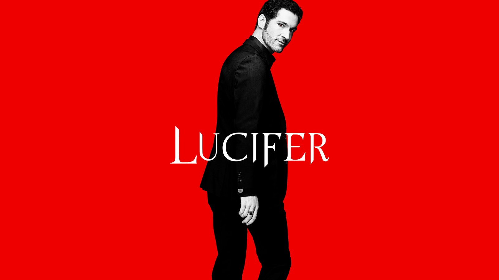 A close up of a man in a suit standing on a red background (lucifer, 5k, tom ellis, lucifer morningstar, red background)