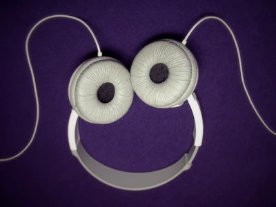 Playful Headphones with Eye Design on Purple Background