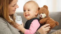 Joyful Bonding: A Mother and Child with a Stuffed Bear