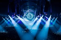 Dynamic Stage Lighting at a Rock Concert Featuring a Sea of Fans and a Vibrant Visual Display