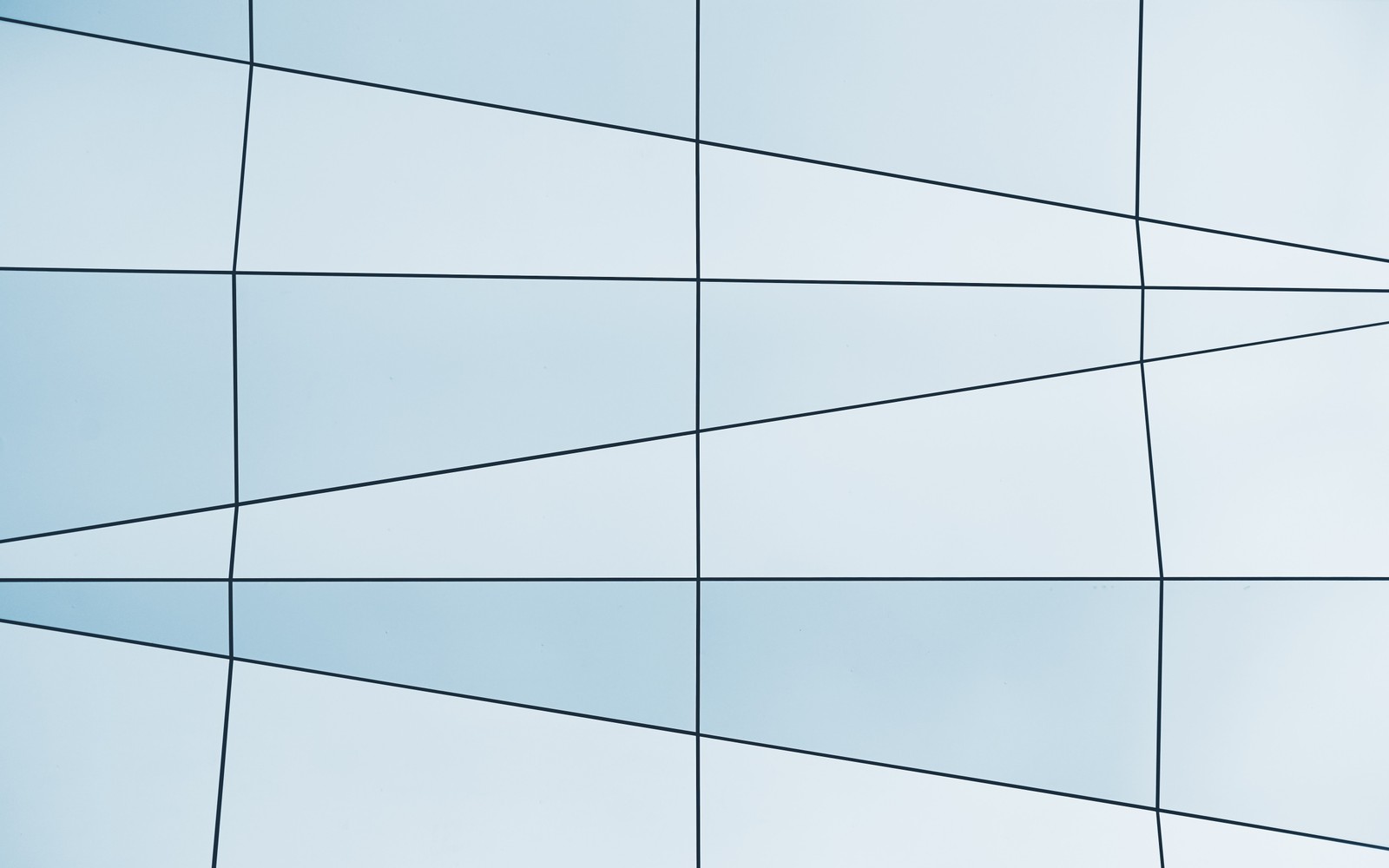 Arafed view of a plane flying in front of a glass building (line, tile, rectangle, pattern, architecture)