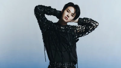 Jungwoo from NCT 127 showcasing a striking fashion look against a minimalist background.