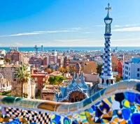 Vibrant View of Barcelona from Park Güell with Mosaic Architecture and Coastal Skyline