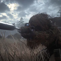 A soldier in military camouflage aims a sniper rifle in a dramatic, foggy landscape, capturing the intensity and strategy of modern warfare in a video game setting.