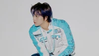 Haechan of NCT 127 in a stylish blue and white ensemble, showcasing his unique charisma and vibrant hairstyle.