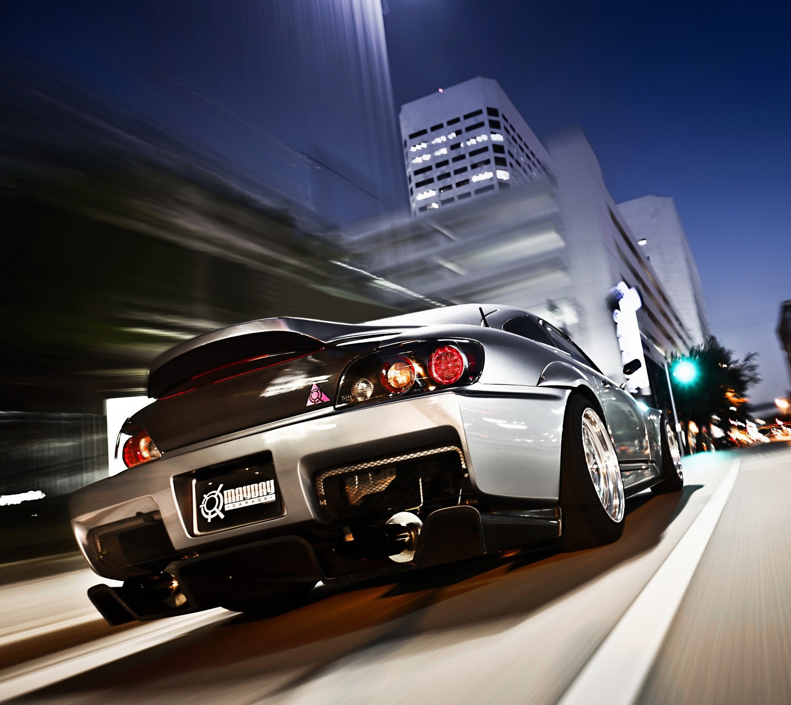 Arafed view of a sports car driving down a city street (car, night, silver)