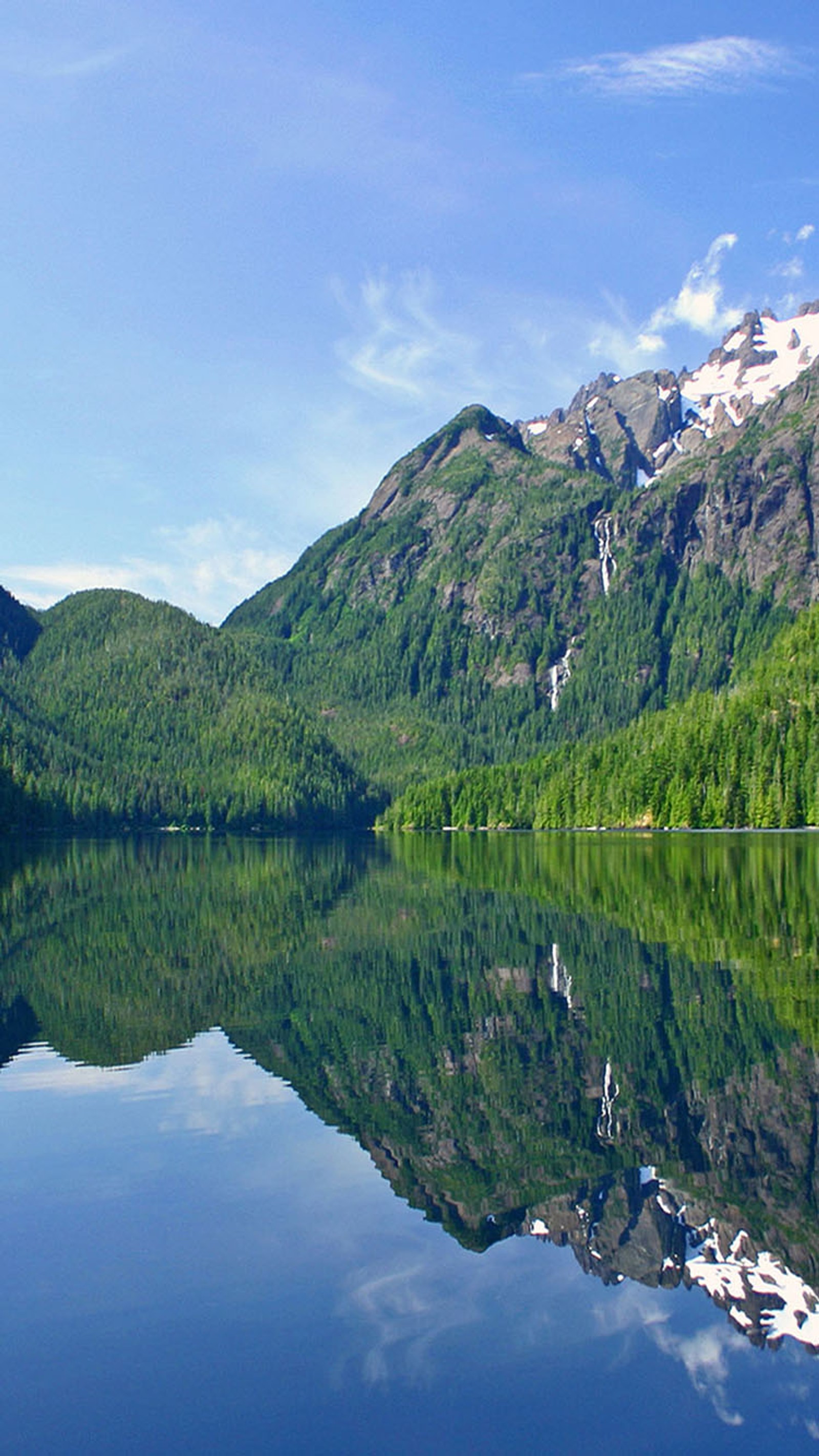 Mountains reflected in a lake with a boat in the foreground (lake, water)