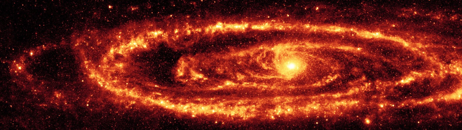 Uma galáxia espiral com um centro vermelho brilhante e um fundo preto (galáxia de andrômeda, andromeda galaxy, galáxia, via láctea, telescópio espacial spitzer)