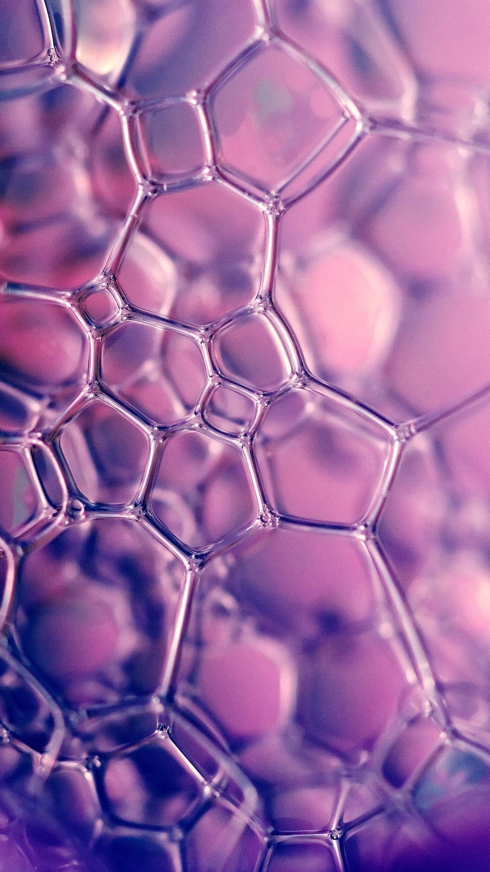 A close up of a bunch of bubbles on a purple surface (mesh, pattern, grey, wire fencing, ball)