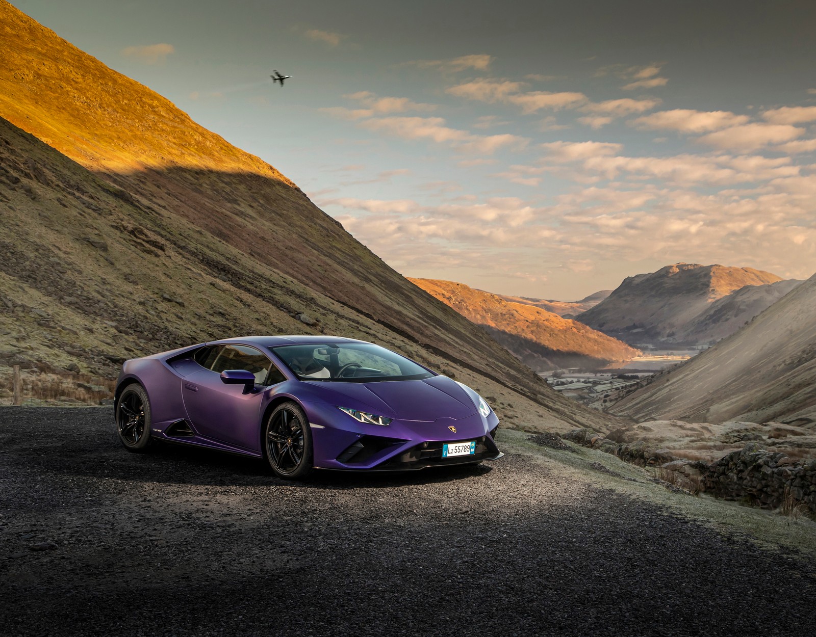 Um carro lambro roxo dirigindo por uma estrada nas montanhas (lamborghini huracan evo rwd, carros esportivos, 2022, carros, papel de parede 4k)