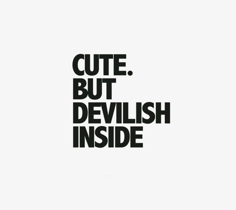 A close up of a black and white poster with a text saying cutie but devilish inside (angel, appearance, awesome, best, cute)