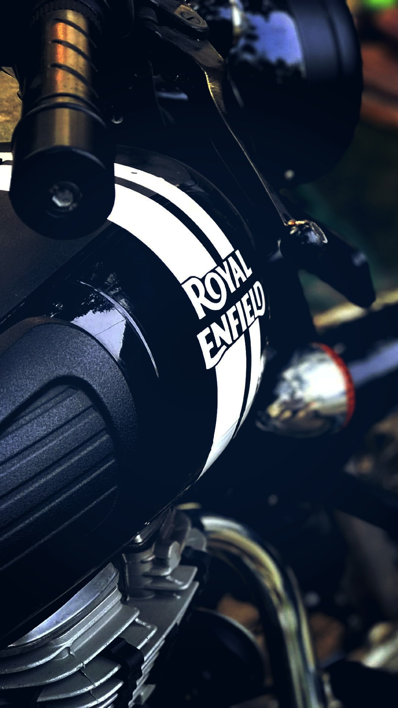 There is a close up of a motorcycle with a black and white stripe (bike, enfield)