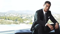 Cristiano Ronaldo in a tailored suit, exuding confidence against a scenic backdrop.