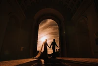 Silhouette of a Couple in Love Holding Hands at Sunset