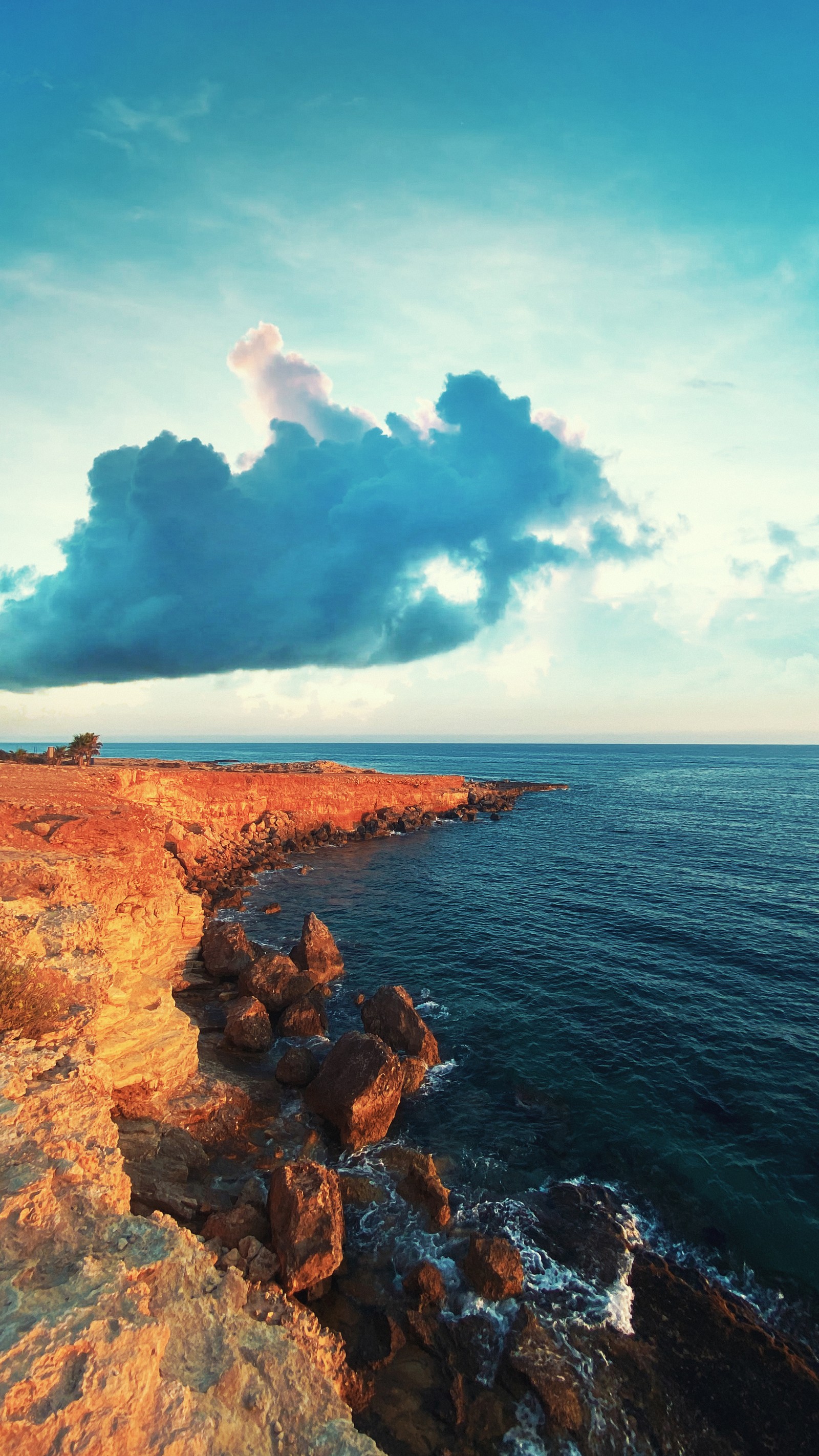 Une personne seule se tient sur une falaise surplombant l'océan (mer, nuage, eau, atmosphère, ressources en eau)