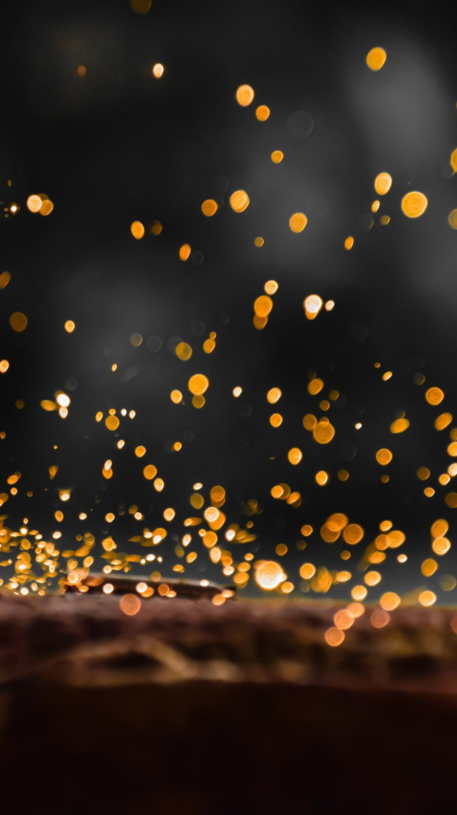 There is a blurry image of a black and gold background (abstract, lights, spark)