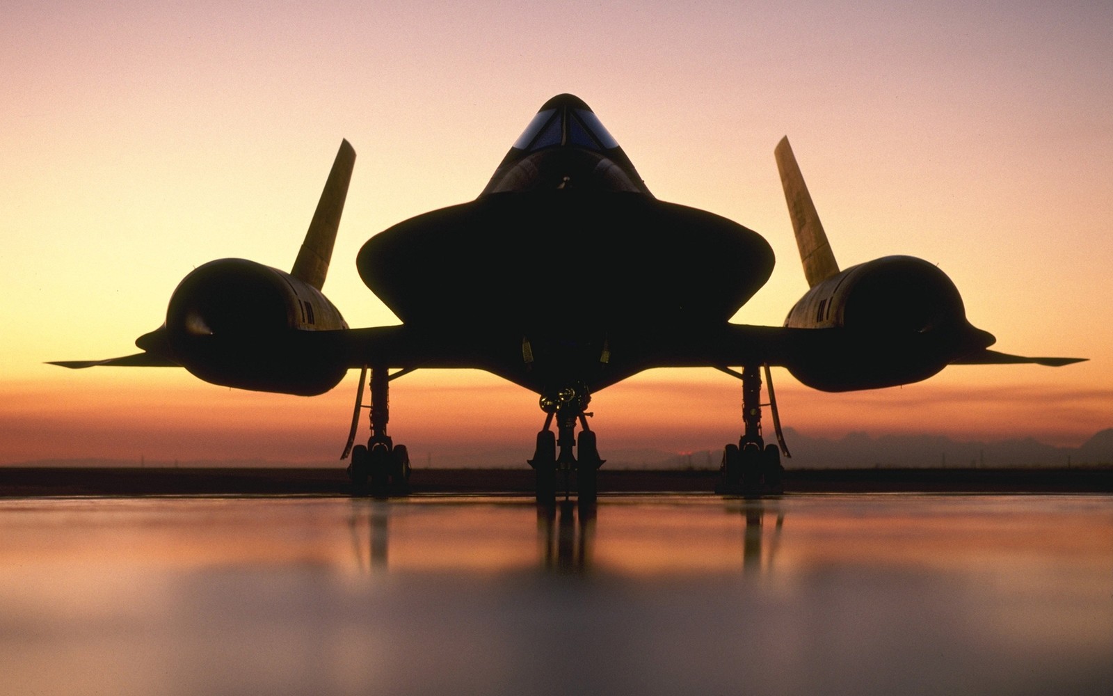 A close up of a jet plane on a runway at sunset (lockheed sr 71 blackbird, aircraft, lockheed martin, jet aircraft, airplane)