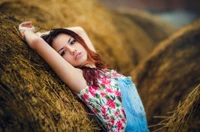 Radiant Beauty in Nature: A Long-Haired Model Amidst Hay Bales