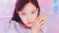 Nayeon from TWICE radiates charm in a dreamy pastel setting, embodying the essence of the "Taste of Love" album.