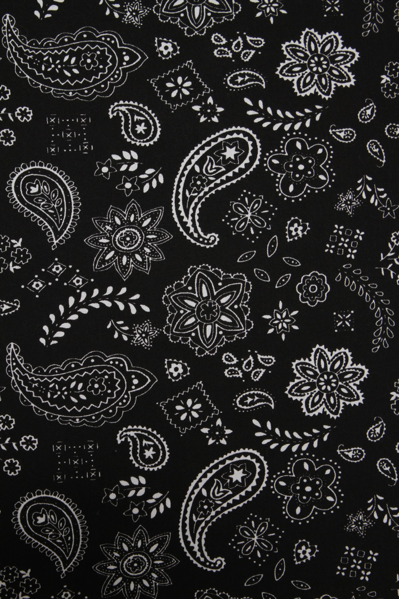 A close up of a black and white paisley print fabric (bandana, black, hdsahdjsad)