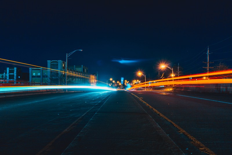 Arafed view of a city street at night with a car streak (autumn, bridges, new, streets)