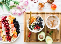 Lebensfrohe Obstsalat und nahrhafte Frühstücksschüssel mit Avocado und Kräutertee