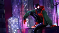 Miles Morales en tant que Spider-Man, perché au sommet d'un paysage urbain la nuit avec des lumières néon vibrantes et des gratte-ciel en arrière-plan.