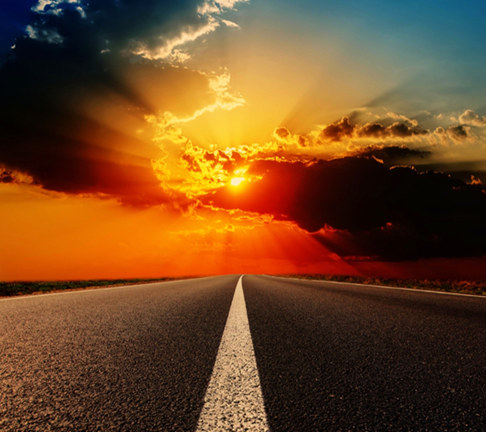 A close up of a road with a sky background and a sun setting (clouds, freeway, highway, new, nice)