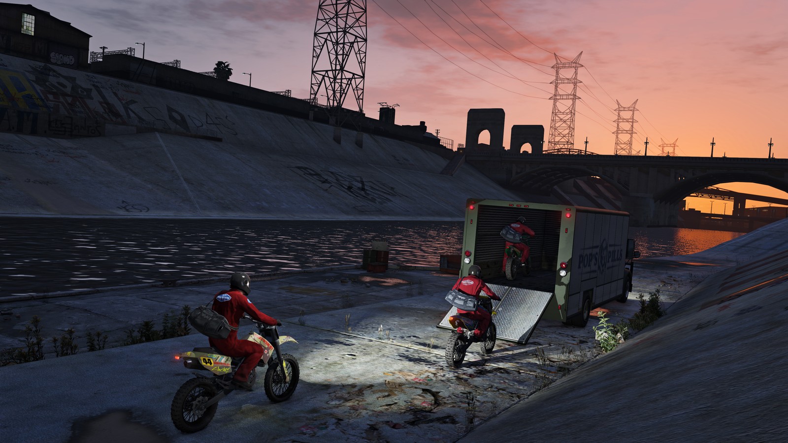 Arafed motorcyclists are parked near a bridge at sunset (grand theft auto v, playstation 4, rockstar games, xbox one, xbox 360)