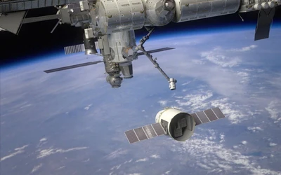 Dragon Spacecraft Approaching the International Space Station Above Earth