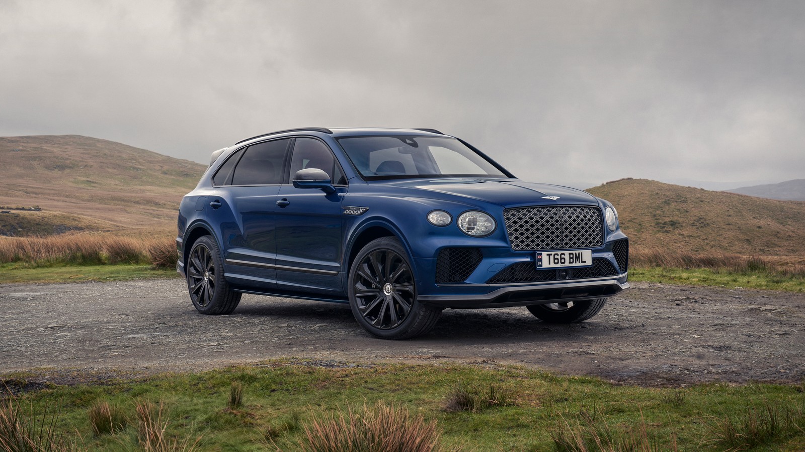 The bentley suv is parked on a gravel road in the mountains (bentley bentayga ewb, mulliner, 2024, cars, 4k wallpaper)