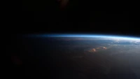 Earth's Atmosphere Glowing Against the Cosmic Horizon