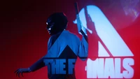 Dynamic character in a dramatic pose, holding a weapon, set against a vibrant background with the logo "The Finals.