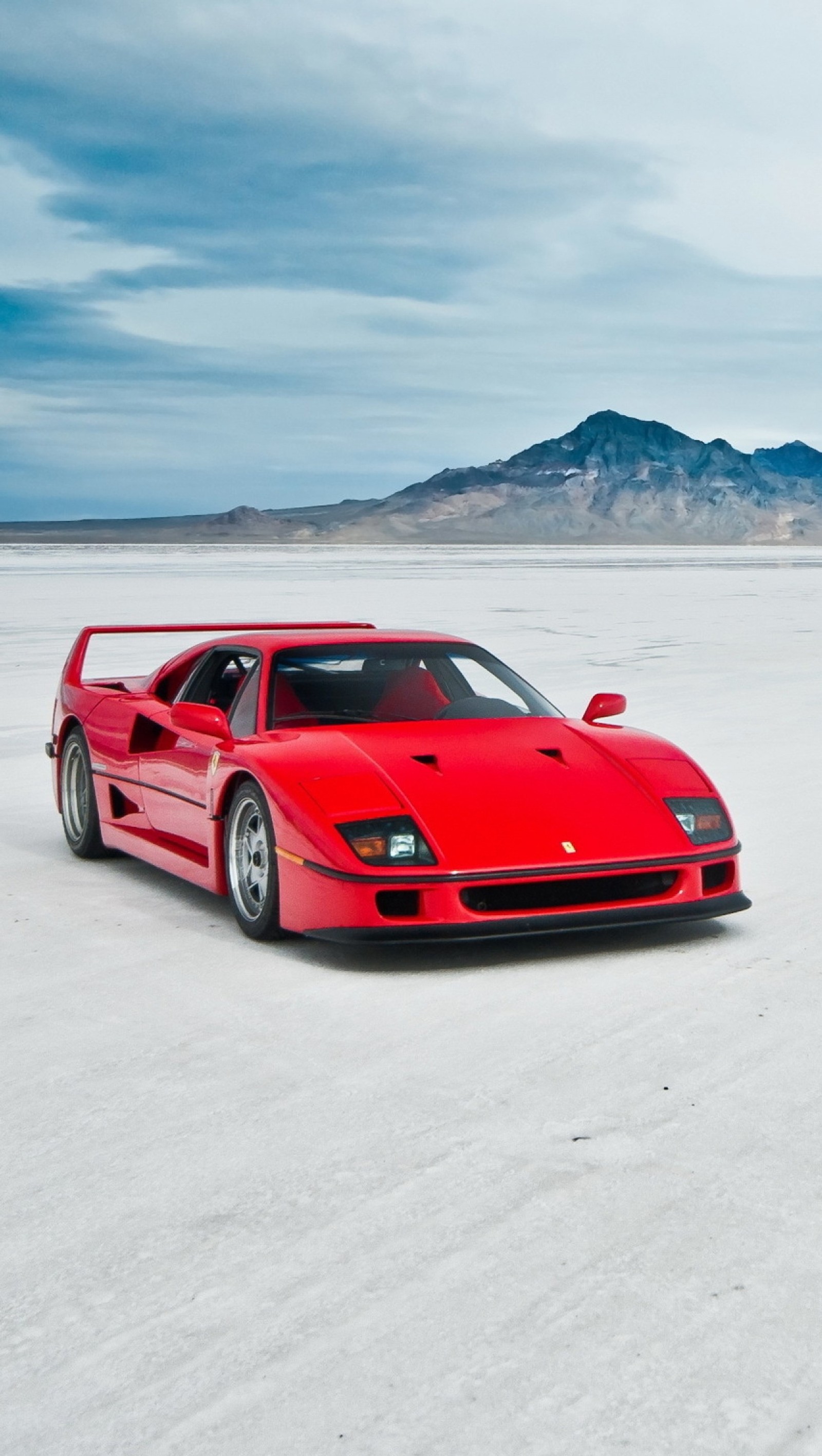 Ferrari sports car in the desert with mountains in the background (f40, ferrari)