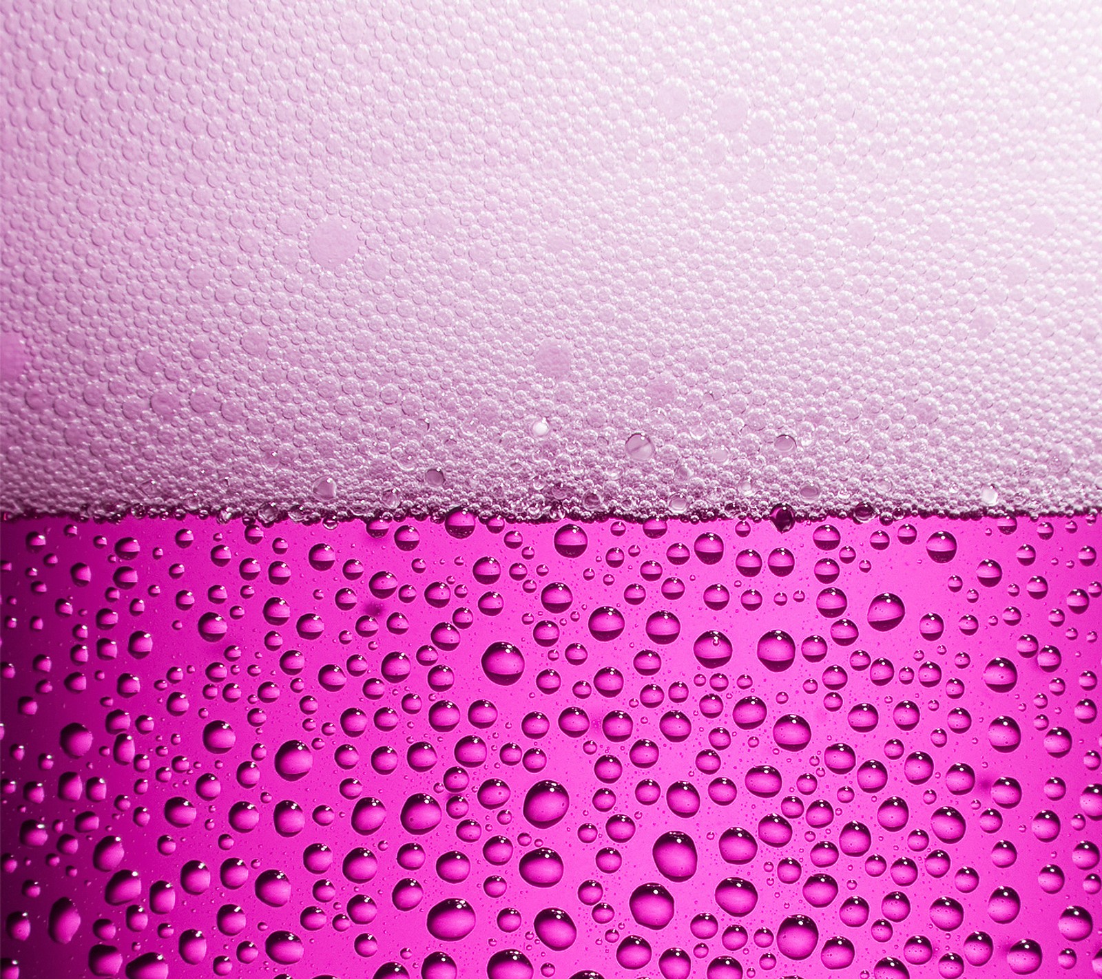 A close up of a pink liquid filled glass with bubbles (abstract, colors, fruit, juice, karmughil)