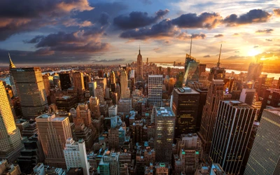 New York City Skyline at Sunset: Aerial View of Skyscrapers Under a Cloudy Evening Sky