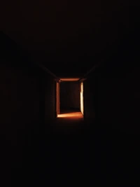 Illuminated Doorway in Darkness