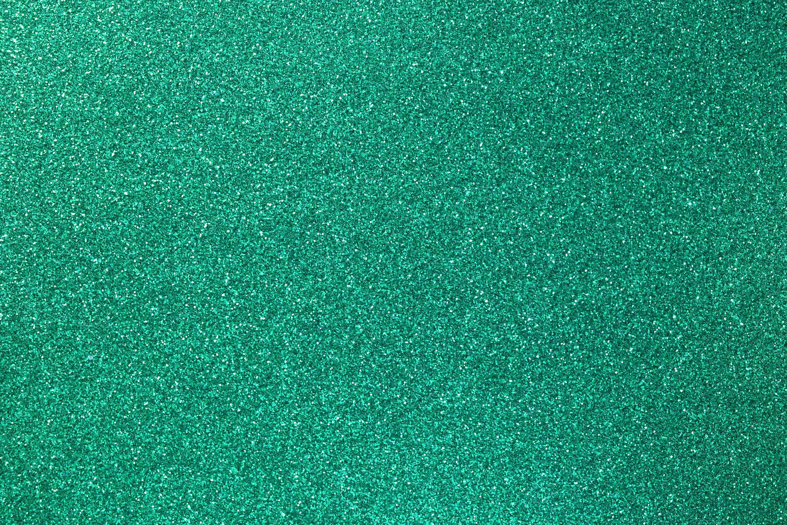 A close up of a green glittered background with a white border (green, blue, aqua, turquoise, teal)