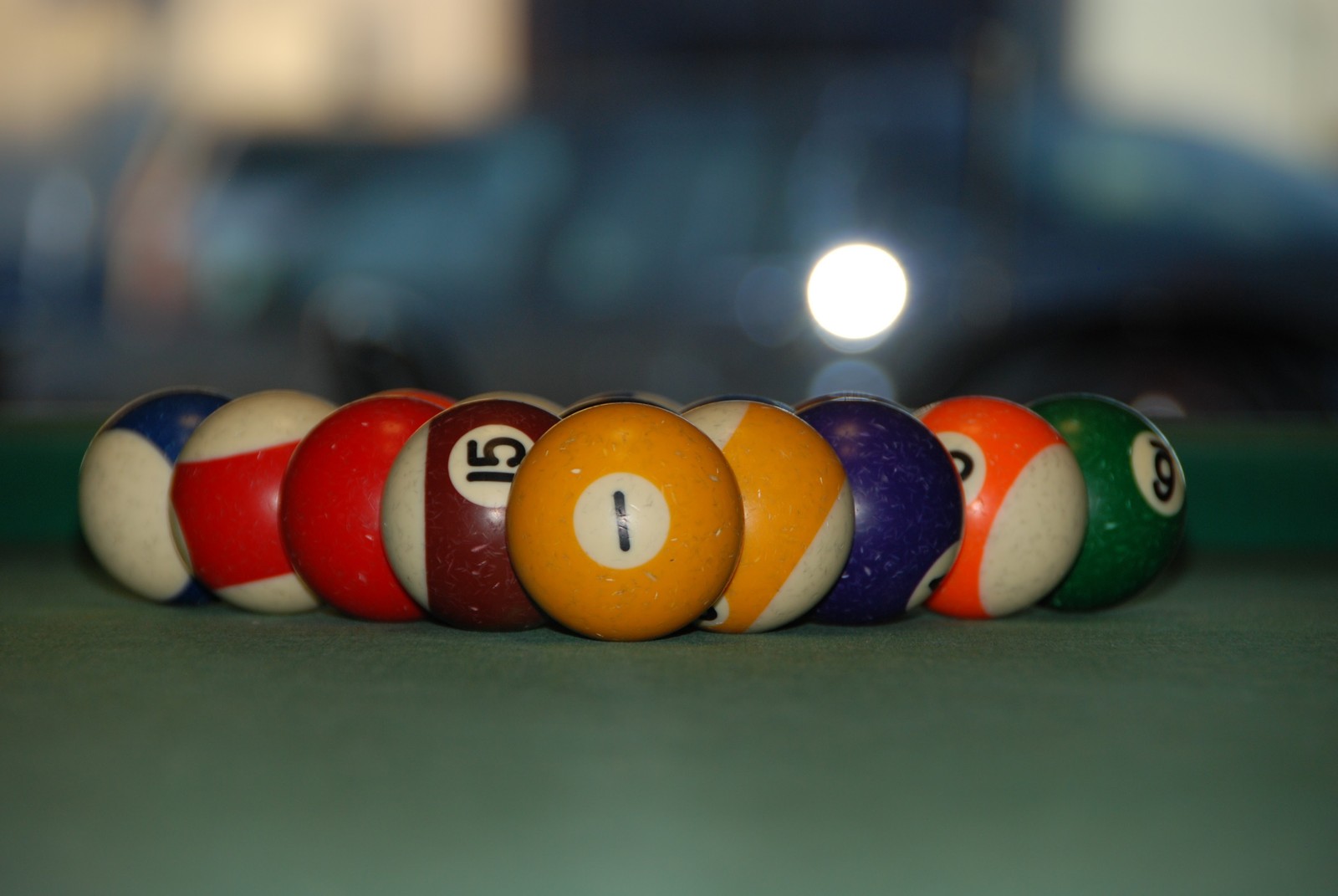 A close up of a pool table with a number of billiards (billiard ball, pool, indoor games and sports, games, ball)