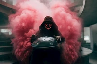 Hooded Man with Neon Mask Playing Handpan Amidst Pink Smoke