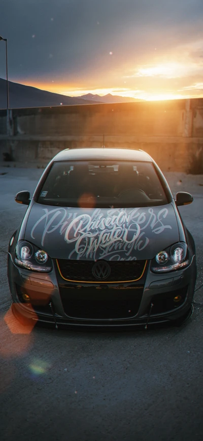 Carro compacto Volkswagen personalizado ao pôr do sol com gráficos únicos