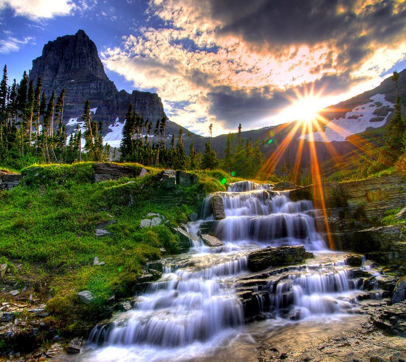 A close up of a waterfall in a mountain with a mountain in the background (nature, wallpaper)