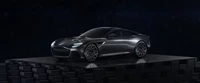 Aston Martin DBS Superleggera на темном пьедестале, демонстрирующий гладкие линии на черном фоне.