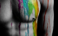 Vibrant Expression: Colorful Paint Dripping on a Male Torso