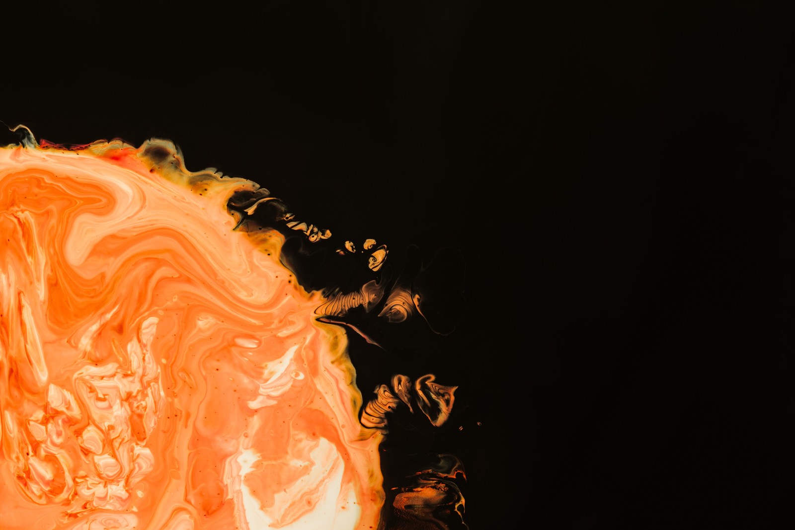 There is a close up of a slice of orange with a black background (orange, macbook, apple macbook pro, red, texture)