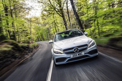 Mercedes-Benz Classe C traversant un paysage forestier luxuriant